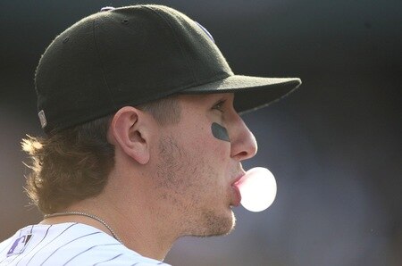 DENVER - OCTOBER 11:  Troy Tulowitzki #2 of the Colorado Rockies blows a bubble with gum before the game against the Philadelphia Phillies in Game Four of the NLDS during the 2009 MLB Playoffs at Coors Field on October 12, 2009 in Denver, Colorado.  <br /><br /><span class="help">(Photo by Jed Jacobsohn/ Getty Images)</span>