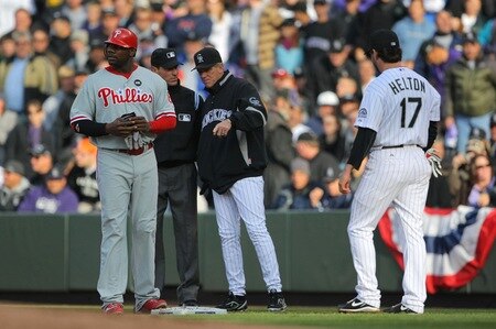 DENVER - OCTOBER 11:  Manager Jim Tracy #4 of the Colorado Rockies discusses a fielder's choice call with first base umpire Angel Hernandez #55 as Ryan Howard #6 of the Philadelphia Phillies and Todd Helton #17 of the Colorado Rockies stand by in Game Four of the NLDS during the 2009 MLB Playoffs at Coors Field on October 12, 2009 in Denver, Colorado.  <br /><br /><span class="help">(Photo by Doug Pensinger/Getty Images)</span>