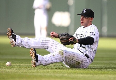 DENVER - OCTOBER 12:  Clint Barmes #12 of the Colorado Rockies can't come up with the ball on a single by Carlos Ruiz #51 of the Philadelphia Phillies in the top of the second inning in Game Four of the NLDS during the 2009 MLB Playoffs at Coors Field on October 12, 2009 in Denver, Colorado. <br /><br /><span class="help">(Photo by Jed Jacobsohn/Getty Images)</span>