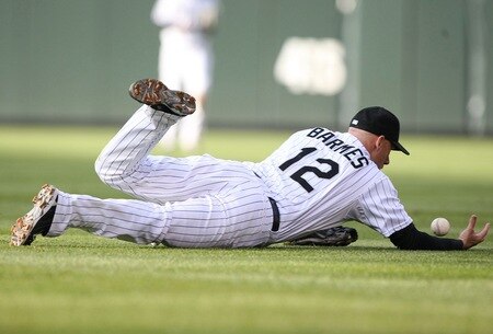 DENVER - OCTOBER 12:  Clint Barmes #12 of the Colorado Rockies can't come up with the ball on a single by Carlos Ruiz #51 of the Philadelphia Phillies in the top of the second inning in Game Four of the NLDS during the 2009 MLB Playoffs at Coors Field on October 12, 2009 in Denver, Colorado. <br /><br /><span class="help">(Photo by Jed Jacobsohn/Getty Images)</span>