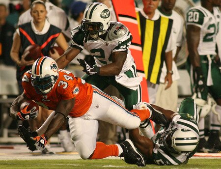 MIAMI - OCTOBER 12:  Running back Rickey Williams #34 of the Miami Dolphins is brought down b corner back Darrelle Revis #24 and linebacker Jamaal Westerman #55 of the New York Jets at Land Shark Stadium on October 12, 2009 in Miami, Florida.  <br /><br /><span class="help">(Photo by Marc Serota/Getty Images)</span>