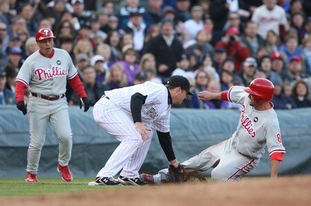 DENVER - OCTOBER 11:  Shane Victorino #8 of the Philadelphia Phillies slides safely into third base against Garrett Atkins #27 of the Colorado Rockies in the top of the third inning in Game Four of the NLDS during the 2009 MLB Playoffs at Coors Field on October 12, 2009 in Denver, Colorado. <br /><br /><span class="help">(Photo by Jed Jacobsohn/Getty Images)</span>