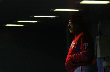 DENVER - OCTOBER 11:  Third base coach Sam Perlozzo #2 of the Philadelphia Phillies watches the play from the dugout against the Colorado Rockies in Game Four of the NLDS during the 2009 MLB Playoffs at Coors Field on October 12, 2009 in Denver, Colorado. <br /><br /><span class="help">(Photo by Doug Pensinger/Getty Images)</span>