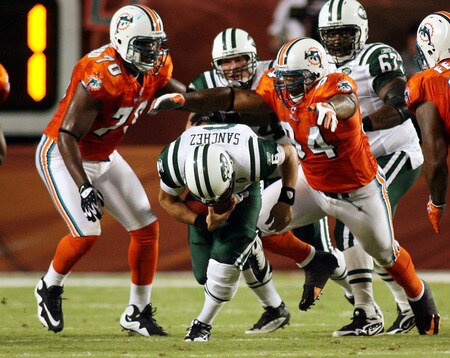 MIAMI - OCTOBER 12:  Quarterback Mark Sanchez #6 of the New York Jets is sacked by defensive end Randy Starks #94 of the Miami Dolphins at Land Shark Stadium on October 12, 2009 in Miami, Florida.  <br /><br /><span class="help">(Photo by Marc Serota/Getty Images)</span>