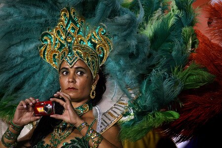 MIAMI - OCTOBER 12:  A halftime dancer for Spanish Heratige month takes a photo during the Miami Dolphins against the New York Jets game at Land Shark Stadium on October 12, 2009 in Miami, Florida.  <br /><br /><span class="help">(Photo by Marc Serota/Getty Images)</span>