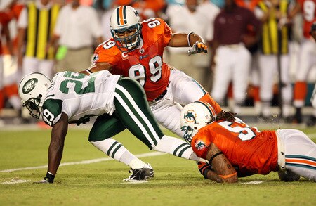 MIAMI - OCTOBER 12:  Running back Leon Washington #29 of the New York Jets tries to slip a tackle attempt by linebackers Channing Crowder #52 and Jason Taylor #99 of the Miami Dolphins at Land Shark Stadium on October 12, 2009 in Miami, Florida.  <br /><br /><span class="help">(Photo by Doug Benc/Getty Images)</span>