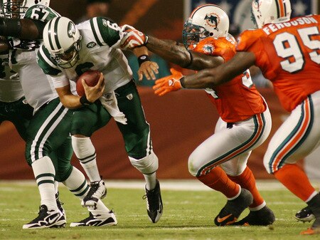MIAMI - OCTOBER 12:  Quarterback Mark Sanchez #6 of the New York Jets is sacked by defensive end Randy Starks #94 of the Miami Dolphins at Land Shark Stadium on October 12, 2009 in Miami, Florida.  <br /><br /><span class="help">(Photo by Marc Serota/Getty Images)</span>