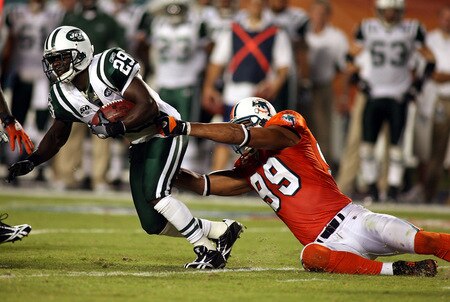 MIAMI - OCTOBER 12:  Running back Leon Washington #29 of the New York Jets is brought down by defensive lineman Jasoon Taylor #99 of the Miami Dolphins at Land Shark Stadium on October 12, 2009 in Miami, Florida.  <br /><br /><span class="help">(Photo by Marc Serota/Getty Images)</span>