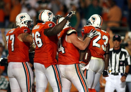 MIAMI - OCTOBER 12:  Running back Ronnie Brown #23 of the Miami Dolphins celebrates scoring the game winning touchdown against the New York Jets fans prior to their game at Land Shark Stadium on October 12, 2009 in Miami, Florida. Miami defeated New York 31-27. <br /><br /><span class="help">(Photo by Marc Serota/Getty Images)</span>