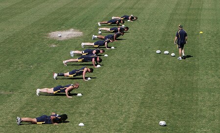 SYDNEY, AUSTRALIA - OCTOBER 13:  Kangaroos coach Tim Sheens (R) runs his team through push up drills during an Australian Kangaroos training session at Concord Oval on October 13, 2009 in Sydney, Australia.  <br /><br /><span class="help">(Photo by Robert Gray/Getty Images)</span>