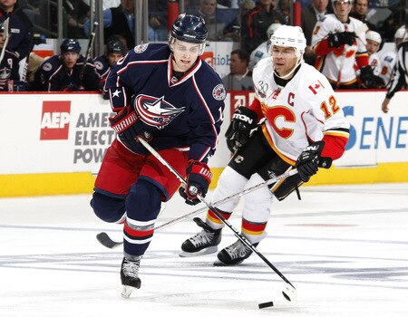 COLUMBUS, OH - OCTOBER 13:  Kris Russell #10 of the Columbus Blue Jackets controls the puck in front of Jerome Iginla #12 of the Calgary Flames on October 13, 2009 at Nationwide Arena in Columbus, Ohio. Columbus won the game 2-1.  <br /><br /><span class="help">(Photo by Gregory Shamus/Getty Images)</span>