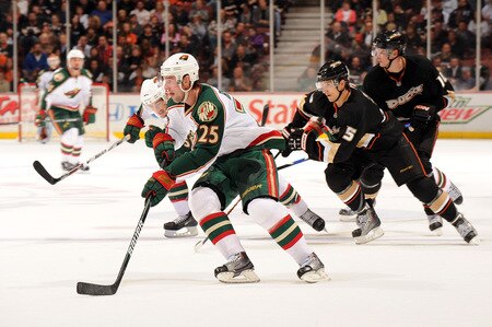 ANAHEIM, CA - OCTOBER 14:  Eric Belanger #25 of the Minnesota Wild picks up a lose puck in front of Luca Sbisa #5 and Corey Perry #10 of the Anaheim Ducks during the second period at the Honda Center on October 14, 2009 in Anaheim, California.  <br /><br /><span class="help">(Photo by Harry How/Getty Images)</span>