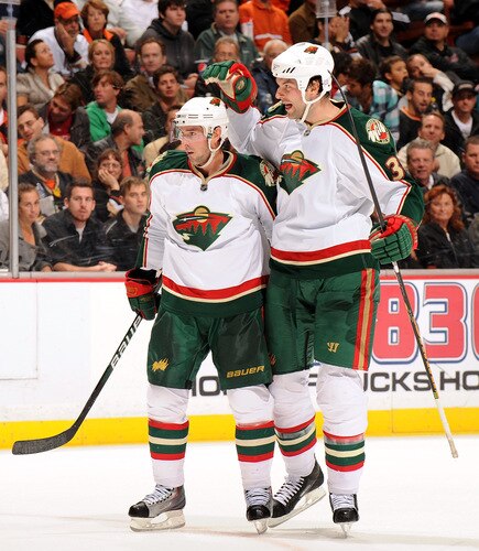 ANAHEIM, CA - OCTOBER 14:  Eric Belanger #25 of the Minnesota Wild gets a hug from teammate John Scott #36 after his goal agaisnt the Anaheim Ducks to trail 1-3 during the second period at the Honda Center on October 14, 2009 in Anaheim, California.  <br /><br /><span class="help">(Photo by Harry How/Getty Images)</span>