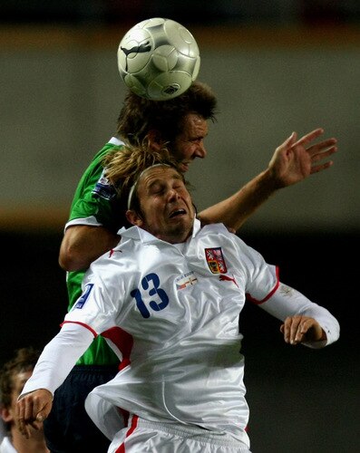 PRAGUE, CZECH REPUBLIC - OCTOBER 14:  Jaroslav Plasil (front) of Czech Republic battles for the ball with Gareth McAuley of Northern Ireland during the FIFA 2010 World Cup Group 3 Qualifier match between Czech Republic and Northern Ireland at the Synot Tip Arena on October 14, 2009 in Prague, Czech Republic.  <br /><br /><span class="help">(Photo by Alexander Hassenstein/Getty Images)</span>