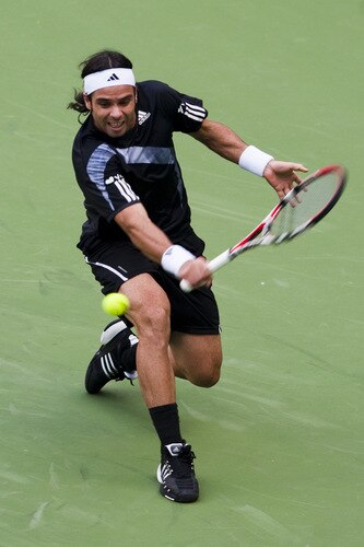 SHANGHAI, CHINA - OCTOBER 15:  Fernando Gonzalez of Chile returns a shot to Nikolay Davydenko of Russia during day five of 2009 Shanghai ATP Masters 1000 at Qi Zhong Tennis Centre on October 15, 2009 in Shanghai, China.  <br /><br /><span class="help">(Photo by Victor Fraile/Getty Images)</span>