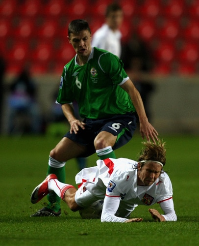 PRAGUE, CZECH REPUBLIC - OCTOBER 14:  Jaroslav Plasil of Czech Republic is tackled by Christopher Baird of Northern Ireland during the FIFA 2010 World Cup Group 3 Qualifier match between Czech Republic and Northern Ireland at the Synot Tip Arena on October 14, 2009 in Prague, Czech Republic.  <br /><br /><span class="help">(Photo by Alexander Hassenstein/Getty Images)</span>