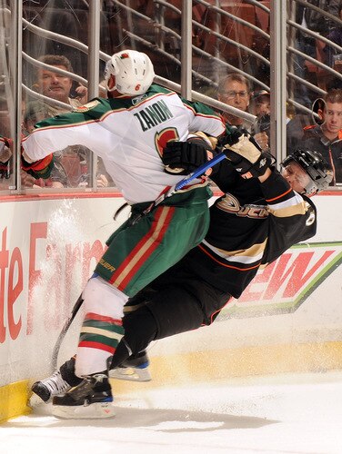 ANAHEIM, CA - OCTOBER 14:  Corey Perry #10 of the Anaheim Ducks collides along the boards with Greg Zanon #6 of the Minnesota Wild during the first period at the Honda Center on October 14, 2009 in Anaheim, California.  <br /><br /><span class="help">(Photo by Harry How/Getty Images)</span>