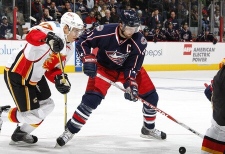 COLUMBUS, OH - OCTOBER 13:  Rick Nash #61 of the Columbus Blue Jackets tries to control the puck in front of Rene Bourque #17 of the Calgary Flames on October 13, 2009 at Nationwide Arena in Columbus, Ohio.  <br /><br /><span class="help">(Photo by Gregory Shamus/Getty Images)</span>