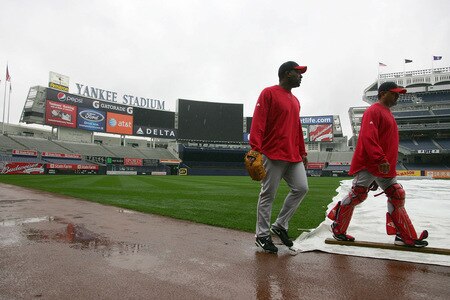 NEW YORK - OCTOBER 15: Darren Oliver #38 and coach Steve Soliz #61 of the Los Angeles Angels of Anaheim walk past the tarp covering the field during workouts on October 15, 2009 at Yankee Stadium in the Bronx borough of New York City.  <br /><br /><span class="help">(Photo by Jared Wickerham/Getty Images)</span>