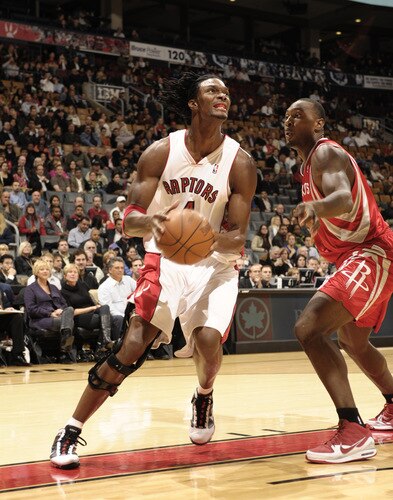 TORONTO - OCTOBER 15: Chris Bosh #4  of the Toronto Raptors slashes to the basket defended by Joey Dorsey #15 of the Houston Rockets during a game on October 15, 2009 at the Air Canada Centre in Toronto, Ontario, Canada.  <br /><br /><span class="help">(Photo by Ron Turenne/NBAE via Getty Images)</span>