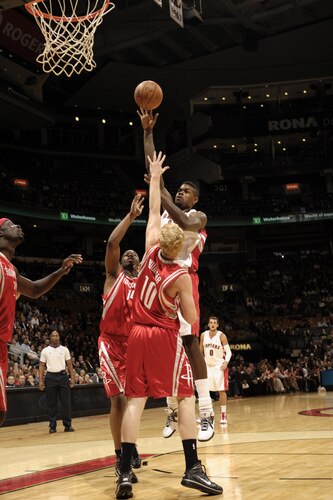 TORONTO - OCTOBER 15: Amir Johnson #15 of the Toronto Raptors tries to sink the hookshot over Chase Budinger #10 of the Houston Rockets during a game on October 15, 2009 at the Air Canada Centre in Toronto, Ontario, Canada.  <br /><br /><span class="help">(Photo by Ron Turenne/NBAE via Getty Images)</span>