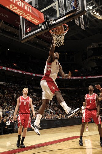 TORONTO - OCTOBER 15: Amir Johnson #15 of the Toronto Raptors manages to break free from the pack and finishes with a slam dunk during a game against the Houston Rockets on October 15, 2009 at the Air Canada Centre in Toronto, Ontario, Canada.  <br /><br /><span class="help">(Photo by Ron Turenne/NBAE via Getty Images)</span>