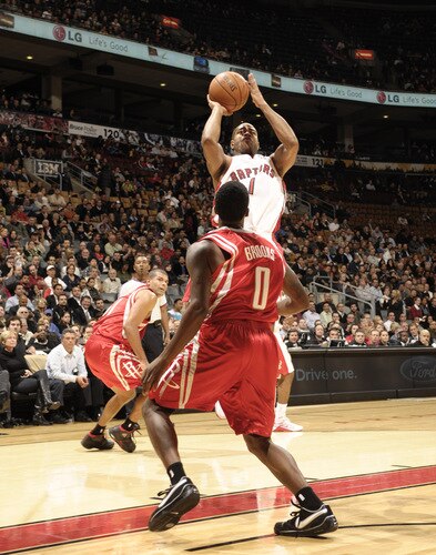 TORONTO - OCTOBER 15: Jarrett Jack #1 of the Toronto Raptors takes the jumper in traffic over Aaron Brooks #0 of the Houston Rockets during a game on October 15, 2009 at the Air Canada Centre in Toronto, Ontario, Canada.  <br /><br /><span class="help">(Photo by Ron Turenne/NBAE via Getty Images)</span>