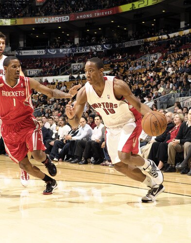 TORONTO - OCTOBER 15: DeMar DeRozan #10 of the Toronto Raptors looks to drive baseline past defender Trevor Ariza #1 of the Houston Rockets during a game on October 15, 2009 at the Air Canada Centre in Toronto, Ontario, Canada.  <br /><br /><span class="help">(Photo by Ron Turenne/NBAE via Getty Images)</span>