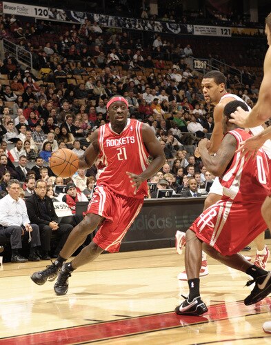 TORONTO - OCTOBER 15:  Pops Mensah-Bonsu #21 of the Houston Rockets looks to drive the paint after getting past Patrick O'Bryant #13 of the Toronto Raptors during a game on October 15, 2009 at the Air Canada Centre in Toronto, Ontario, Canada.  <br /><br /><span class="help">(Photo by Ron Turenne/NBAE via Getty Images)</span>