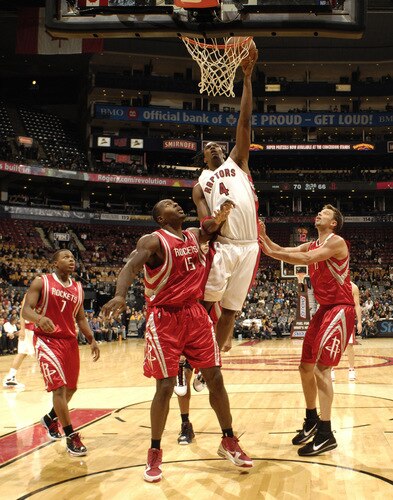 TORONTO - OCTOBER 15:  Chris Bosh #4 of the Toronto Raptors looks to sink the finger roll next to Joey Dorsey #15 of the Houston Rockets during a game on October 15, 2009 at the Air Canada Centre in Toronto, Ontario, Canada.  <br /><br /><span class="help">(Photo by Ron Turenne/NBAE via Getty Images)</span>