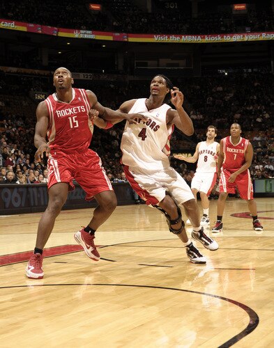 TORONTO - OCTOBER 15:  Chris Bosh #4 of the Toronto Raptors battles near the basket for position with Joey Dorsey #15 of the Houston Rockets during a game on October 15, 2009 at the Air Canada Centre in Toronto, Ontario, Canada.  <br /><br /><span class="help">(Photo by Ron Turenne/NBAE via Getty Images)</span>