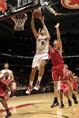 TORONTO - OCTOBER 15:  Marco Belinelli #0 of the Toronto Raptors glides to the basket in front of defender David Anderson #13 of the Houston Rockets during a game on October 15, 2009 at the Air Canada Centre in Toronto, Ontario, Canada.  <br /><br /><span class="help">(Photo by Ron Turenne/NBAE via Getty Images)</span>