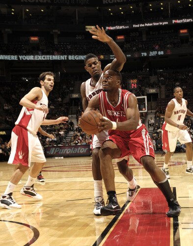 TORONTO - OCTOBER 15:  Carl Landry #14 of the Houston Rockets looks to go under his defender Amir Johnson #15 of the Toronto Raptors during a game on October 15, 2009 at the Air Canada Centre in Toronto, Ontario, Canada.  <br /><br /><span class="help">(Photo by Ron Turenne/NBAE via Getty Images)</span>