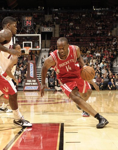 TORONTO - OCTOBER 15:  Carl Landry #14 of the Houston Rockets drives past his defender Amir Johnson #15 of the Toronto Raptors on his way to the basket during a game on October 15, 2009 at the Air Canada Centre in Toronto, Ontario, Canada.  <br /><br /><span class="help">(Photo by Ron Turenne/NBAE via Getty Images)</span>