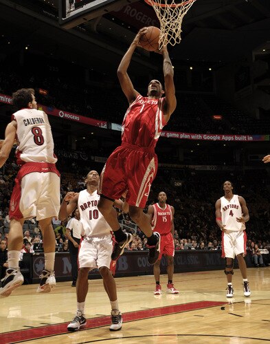 TORONTO - OCTOBER 15:  Trevor Ariza #1 of the Houston Rockets attacks the basket getting past defender Jose Calderon #8 of the Toronto Raptors during a game on October 15, 2009 at the Air Canada Centre in Toronto, Ontario, Canada.  <br /><br /><span class="help">(Photo by Ron Turenne/NBAE via Getty Images)</span>