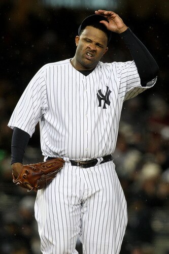 NEW YORK - OCTOBER 16:  CC Sabathia #52 of the New York Yankees reacts while pitching against the Los Angeles Angels of Anaheim in Game One of the ALCS during the 2009 MLB Playoffs at Yankee Stadium on October 16, 2009 in New York, New York.  <br /><br /><span class="help">(Photo by Jim McIsaac/Getty Images)</span>