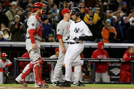 NEW YORK - OCTOBER 16:  Derek Jeter #2 of the New York Yankees scores when Alex Rodriguez #13 hits a sacrifice fly to center field against of the Los Angeles Angels of Anaheim in Game One of the ALCS during the 2009 MLB Playoffs at Yankee Stadium on October 16, 2009 in New York, New York.  <br /><br /><span class="help">(Photo by Jim McIsaac/Getty Images)</span>