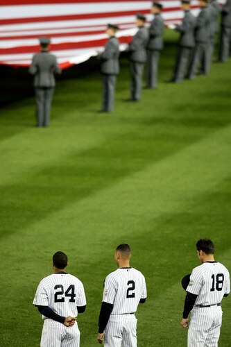 NEW YORK - OCTOBER 16:  Robinson Cano #24, Derek Jeter #2 and Johnny Damon #18 of the New York Yankees stand for the national anthem before Game One of the ALCS against of the Los Angeles Angels of Anaheim during the 2009 MLB Playoffs at Yankee Stadium on October 16, 2009 in New York, New York.  <br /><br /><span class="help">(Photo by Nick Laham/Getty Images)</span>