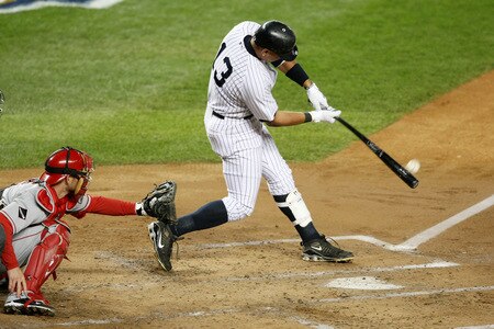 NEW YORK - OCTOBER 16:  Alex Rodriguez #13 of the New York Yankees hits a sacrifice fly to center field driving in Derek Jeter #2 in the first inning against of the Los Angeles Angels of Anaheim in Game One of the ALCS during the 2009 MLB Playoffs at Yankee Stadium on October 16, 2009 in New York, New York.  <br /><br /><span class="help">(Photo by Nick Laham/Getty Images)</span>