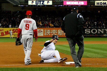 NEW YORK - OCTOBER 16:  Mark Teixeira #25 of the New York Yankees slides into third base while Chone Figgins #9 of the Los Angeles Angels of Anaheim looks on in the bottom of the third inning of Game One of the ALCS during the 2009 MLB Playoffs at Yankee Stadium on October 16, 2009 in New York, New York.  <br /><br /><span class="help">(Photo by Al Bello/Getty Images)</span>