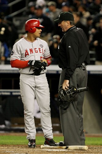 NEW YORK - OCTOBER 16:  Bobby Abreu #53 of the Los Angeles Angels of Anaheim talks with umpire Tim McClelland during Game One of the ALCS against the New York Yankees during the 2009 MLB Playoffs at Yankee Stadium on October 16, 2009 in New York, New York.  <br /><br /><span class="help">(Photo by Al Bello/Getty Images)</span>