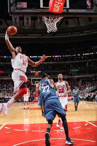 CHICAGO - OCTOBER 16:  James Johnson #16 of the Chicago Bulls dunks over Corey Brewer #22 of the Minnesota Timberwolves on October 16, 2009 at the United Center in Chicago, Illinois.  <br /><br /><span class="help">(Photo by Gary Dineen/NBAE via Getty Images)</span>