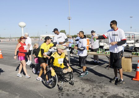 SAN ANTONIO - OCTOBER 17: San Antonio Spurs players Antonio McDyess (center left in ball cap), Curtis Jerrells (center) and Tim Duncan (right) gives water to runners the during the Spurs Fast Break 5K on October 17, 2009 in San Antonio, Texas. <br /><br /><span class="help">(Photo by D. Clarke Evans/NBAE via Getty Images)</span>