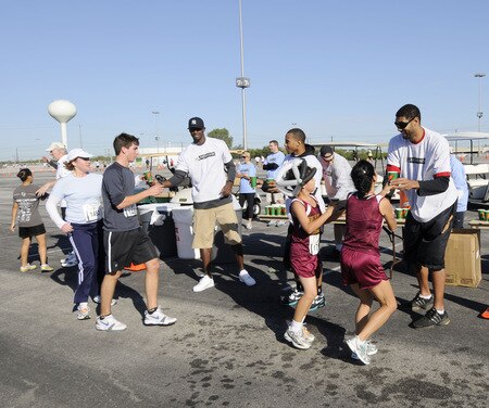 SAN ANTONIO - OCTOBER 17: San Antonio Spurs players Antonio McDyess (center left in ball cap), Curtis Jerrells (center) and Tim Duncan (right) gives water to runners the during the Spurs Fast Break 5K on October 17, 2009 in San Antonio, Texas. <br /><br /><span class="help">(Photo by D. Clarke Evans/NBAE via Getty Images)</span>