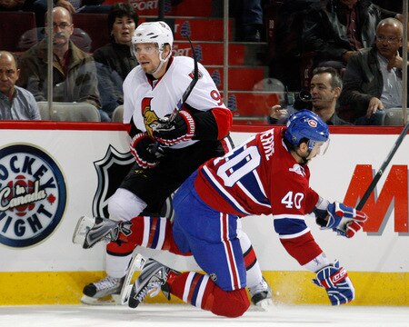 MONTREAL- OCTOBER 17:  Maxim Lapierre #40 of the Montreal Canadiens falls after body checking Milan Michalek #9 of the Ottawa Senators during the NHL game on October 17, 2009 at the Bell Centre in Montreal, Quebec, Canada.  The Senators defeated the Canadiens 3-1.  <br /><br /><span class="help">(Photo by Richard Wolowicz/Getty Images)</span>