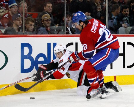 MONTREAL- OCTOBER 17:  Chris Campoli #14 of the Ottawa Senators falls while chasing the puck into the corner with Kyle Chipchura #28 during the NHL game on October 17, 2009 at the Bell Centre in Montreal, Quebec, Canada.  The Senators defeated the Canadiens 3-1.  <br /><br /><span class="help">(Photo by Richard Wolowicz/Getty Images)</span>