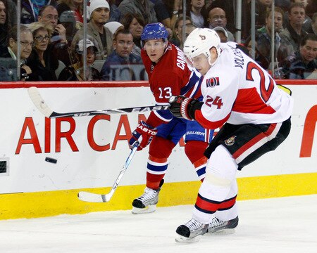 MONTREAL- OCTOBER 17:  Mike Cammalleri #13 of the Montreal Canadiens passes the puck while being defended by Anton Volchenkov #24 of the Ottawa Senators during the NHL game on October 17, 2009 at the Bell Centre in Montreal, Quebec, Canada.  The Senators defeated the Canadiens 3-1.  <br /><br /><span class="help">(Photo by Richard Wolowicz/Getty Images)</span>
