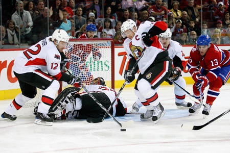 MONTREAL- OCTOBER 17:  Daniel Alfredsson #11 and Mike Fisher #12 of the Ottawa Senators try to clear the puck from in front of Pascal Leclaire #33 during the NHL game against the Montreal Canadiens on October 17, 2009 at the Bell Centre in Montreal, Quebec, Canada.  The Senators defeated the Canadiens 3-1.  <br /><br /><span class="help">(Photo by Richard Wolowicz/Getty Images)</span>