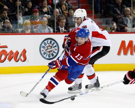 MONTREAL- OCTOBER 17:  Chris Phillips #4 of the Ottawa Senators hooks Mike Cammalleri #13 during the NHL game on October 17, 2009 at the Bell Centre in Montreal, Quebec, Canada.  The Senators defeated the Canadiens 3-1.  <br /><br /><span class="help">(Photo by Richard Wolowicz/Getty Images)</span>