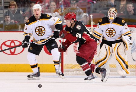GLENDALE, AZ - OCTOBER 17:  Peter Mueller #88 of the Phoenix Coyotes skates with the puck past Derek Morris #53 and Tim Thomas #30 goaltender of the Boston Bruins during the NHL game at Jobing.com Arena on October 17, 2009 in Glendale, Arizona.  <br /><br /><span class="help">(Photo by Christian Petersen/Getty Images)</span>